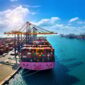 Aerial view of cargo ship and cargo container in harbor.