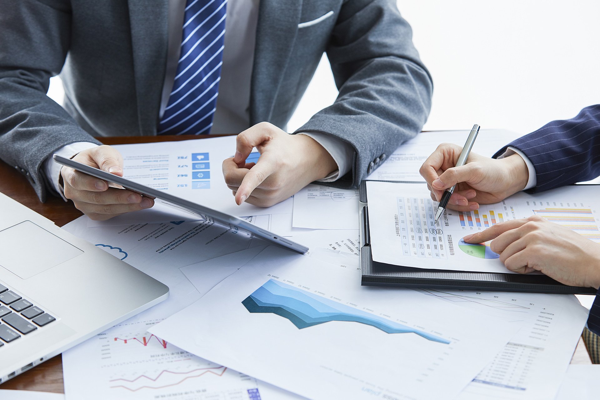 Two businessmen in elegant suits at a business meeting discussing a new project in the office