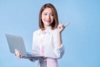 Image of young Asian businesswoman on blue background