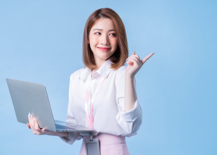 Image of young Asian businesswoman on blue background