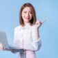 Image of young Asian businesswoman on blue background