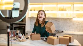 Young beautician. Long-haired cute beaitician conducting an online beauty workshop